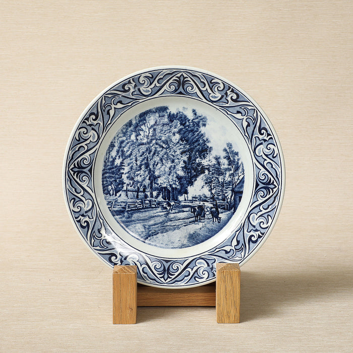 A Petrus Regout delft blue collector's plate featuring a seasonal landscape c. 1890