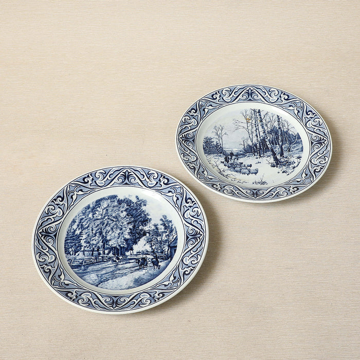 A Petrus Regout delft blue collector's plate featuring a seasonal landscape c. 1890
