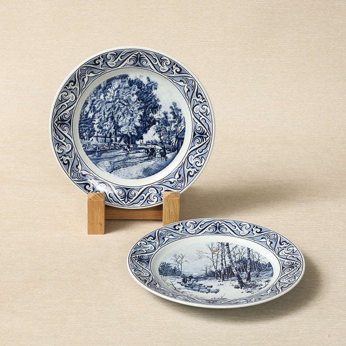 A Petrus Regout delft blue collector's plate featuring a seasonal landscape c. 1890
