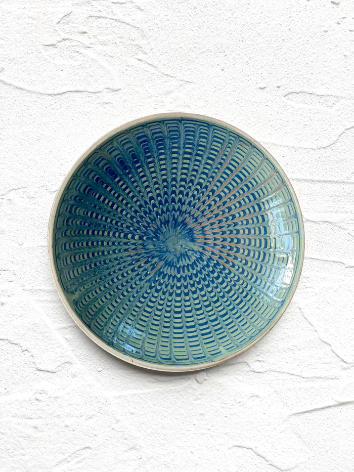 teal and green salad plate with radial peacock pattern