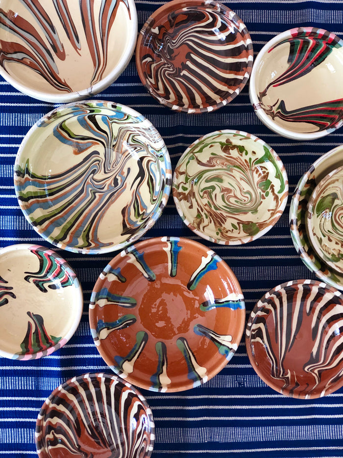 multicolor finger bowls on blue striped tablecloth